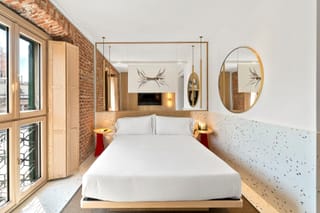 Detail of Superior Double Room with double bed and wall-mounted TV
