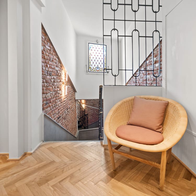 Detail of Hotel Milu Milan’s interior corridors with an armchair